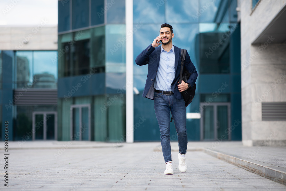 Young middle-eastern entrepreneur going home, talking on phone Young middle-eastern entrepreneur going home, talking on phone