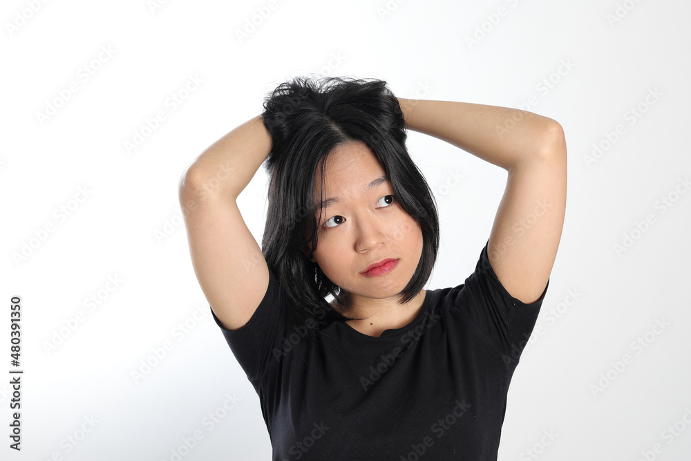Young attractive south east asian woman pose face expression emotion on white background hand in hair dream Young attractive south east asian woman pose face expression emotion on white background hand in hair dream