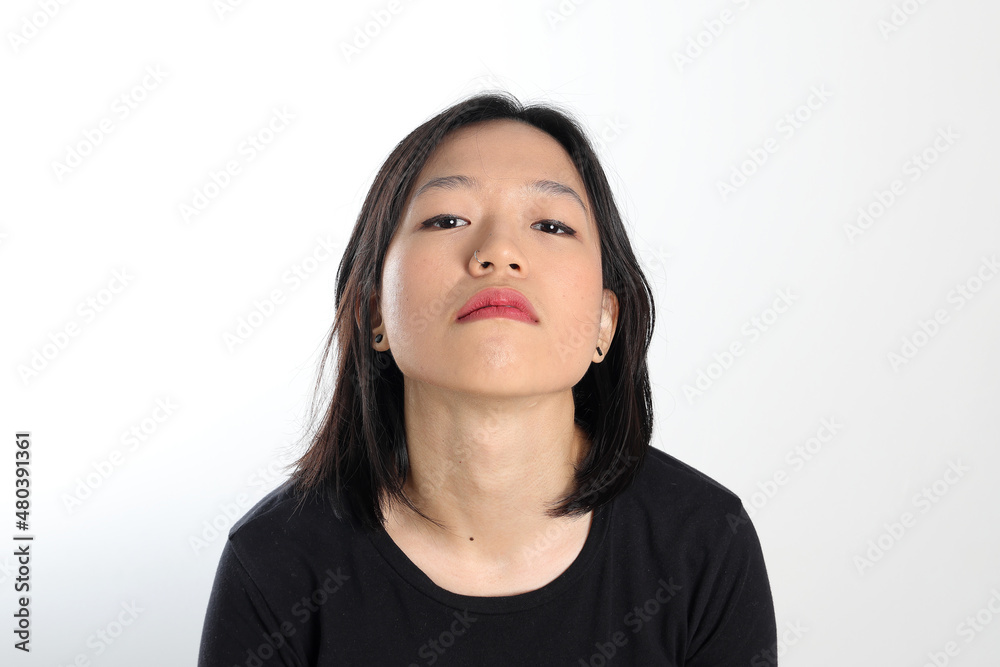 Young attractive south east asian woman pose face expression emotion on white background Young attractive south east asian woman pose face expression emotion on white background