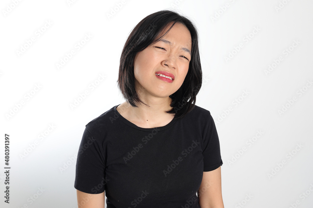 Young attractive south east asian woman pose face expression emotion on white background sad Young attractive south east asian woman pose face expression emotion on white background sad