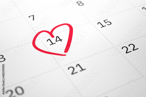 White paper planner calendar with red heart shape mark on 14 February