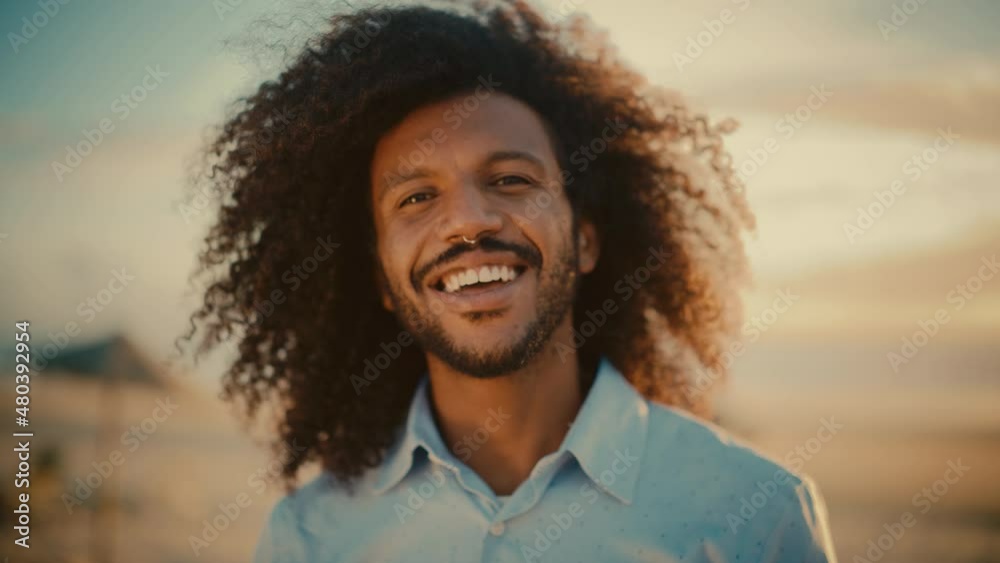 Portrait of a Happy Young Adult Male with Afro Hair and Nose Ring Piercing Posing for Camera. Handsome Diverse Multiethnic Black Male Smiling. Warm Color Edit. Portrait of a Happy Young Adult Male with Afro Hair and Nose Ring Piercing Posing for Camera. Handsome Diverse Multiethnic Black Male Smiling. Warm Color Edit.