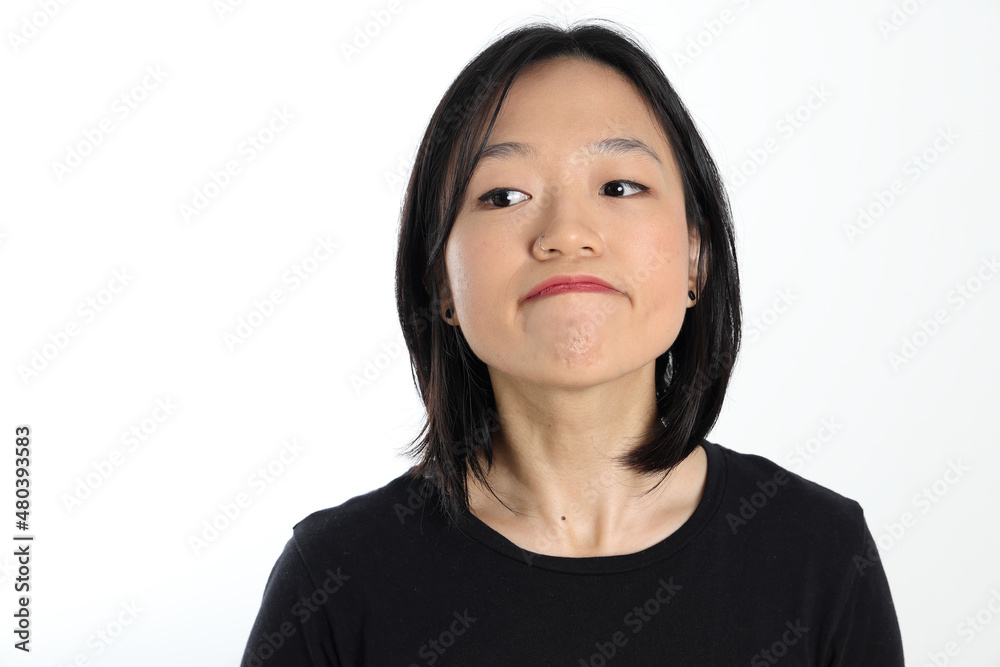 Young attractive south east asian woman pose face expression emotion on white background think look Young attractive south east asian woman pose face expression emotion on white background think look