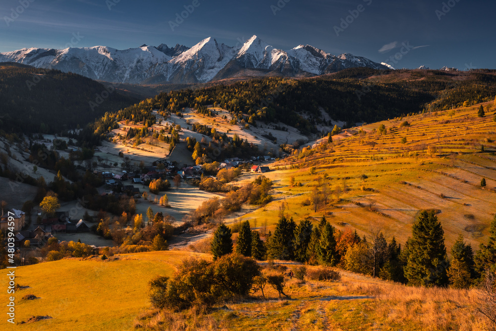 Colorful autumn near the Tatras. Peaks and hills bathed in the light of the setting sun.