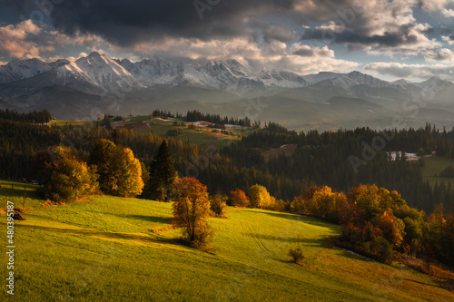 Colorful autumn near the Tatras. Peaks and hills bathed in the light of the setting sun.