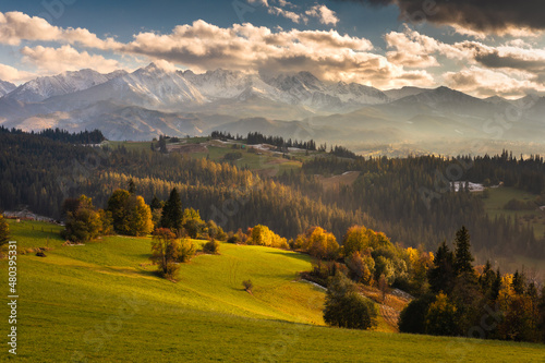 Colorful autumn near the Tatras. Peaks and hills bathed in the light of the setting sun.