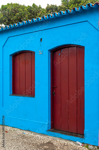Blue Colored House with red Door and Window. City of Porto Seguro. Bahia.