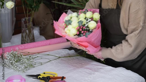 Floral artist working in flower shop studio. Floristry creating flower arrangement. Designing, floral workshop, working concept. Small woman business.