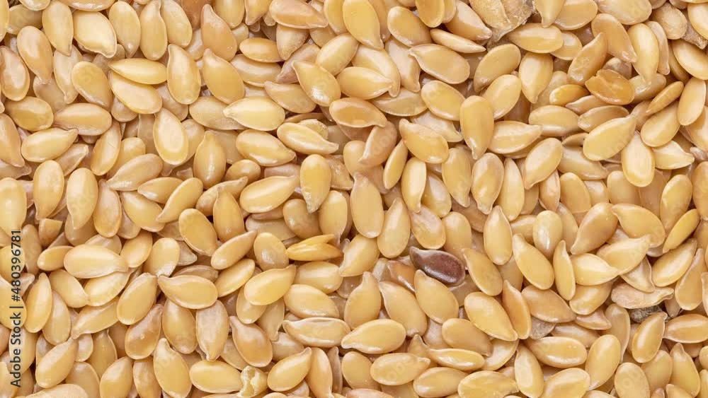 Top view, closeup of golden linseed seeds. Food backdrop Top view, closeup of golden linseed seeds. Food backdrop