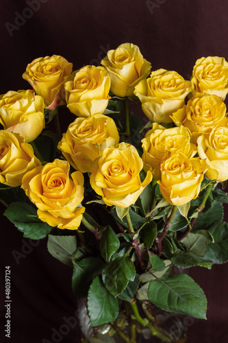 Freshly cut yellow roses on dark background. Beautiful bouquet for Woman s Day