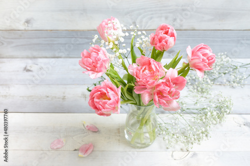 Beautiful fresh pink tulips in vase on background of white boards. Concept of spring bouquet  March 8  women s day  springtime  festive mood  mother s day  holiday  happy birthday. Nobody. Horizontal.