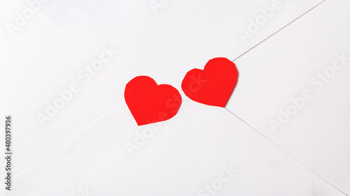 Flat lay white enelope with love letter and red paper hearts Valentines day celebration, Romantic love letter for Valentine's day concept. photo