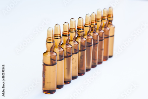 Ampoules with medicine on a white background.