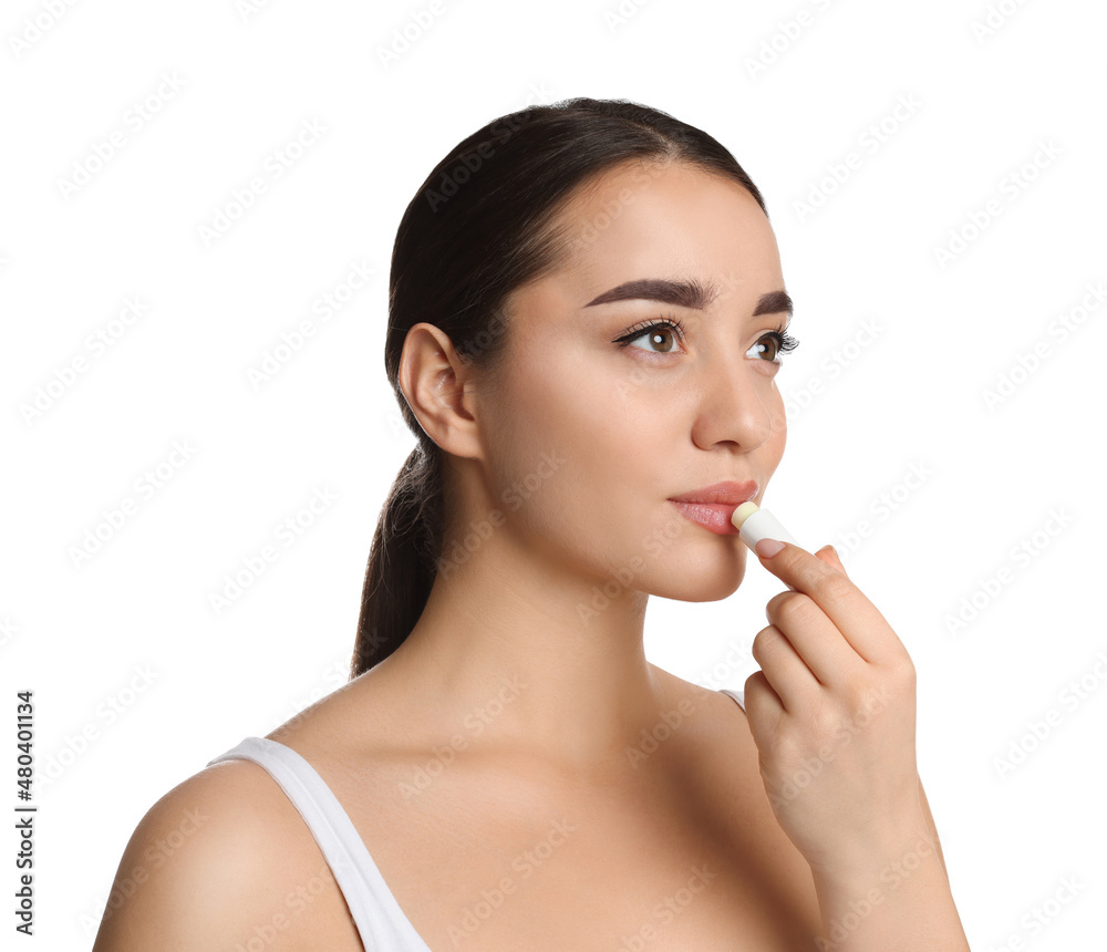 Young woman applying lip balm on white background Young woman applying lip balm on white background