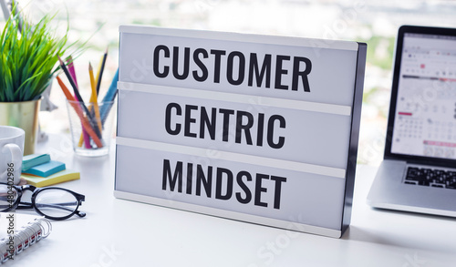 Customer centric mindset text with work table.business service photo