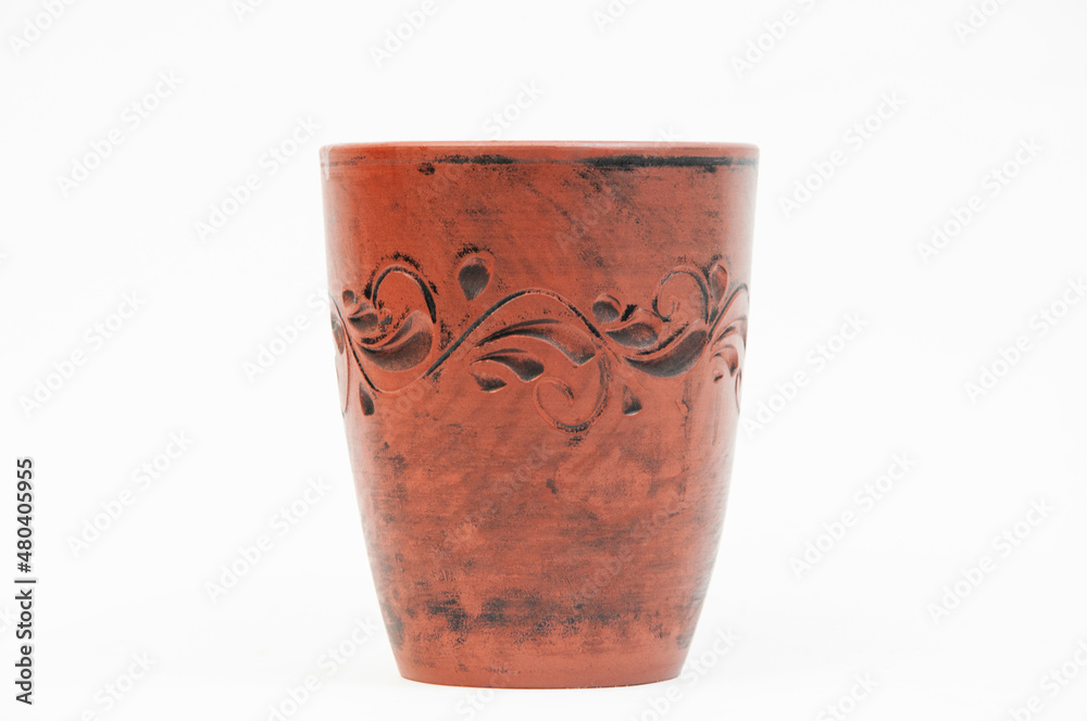 clay cup on a white background. coffee drinking concept. brown glass on a light texture clay cup on a white background. coffee drinking concept. brown glass on a light texture