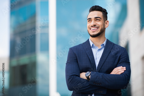 Successful middle-eastern businessman standing next to office