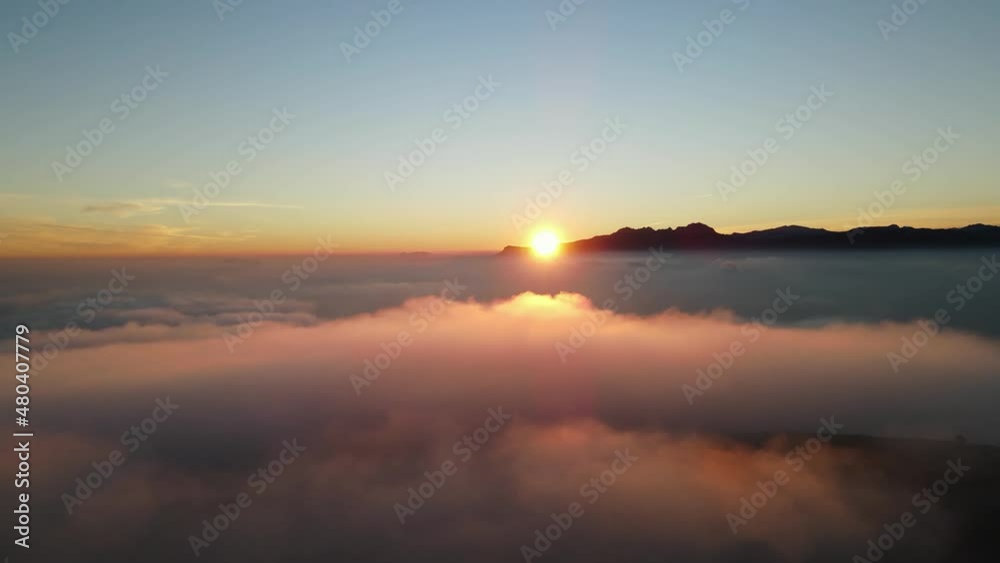 Fooggy sunset in Cumbre del sol. The fog hides the horizon and de coastline. Drone views from Benitachell, Moraira, Calpe and Jávea, in Alicante, Spain Fooggy sunset in Cumbre del sol. The fog hides the horizon and de coastline. Drone views from Benitachell, Moraira, Calpe and Jávea, in Alicante, Spain