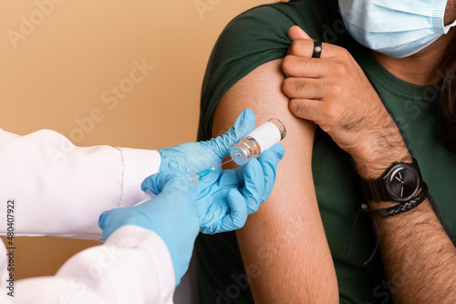 Doctor hands in medical gloves holding vaccine and syringe