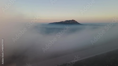 Fooggy sunset in Cumbre del sol. The fog hides the horizon and de coastline. Drone views from Benitachell, Moraira, Calpe and Jávea, in Alicante, Spain photo