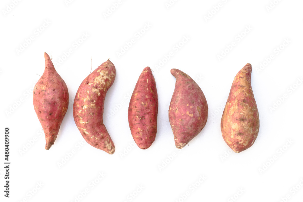 Five purple sweet potatoes are various shapes on a white background. Five purple sweet potatoes are various shapes on a white background.