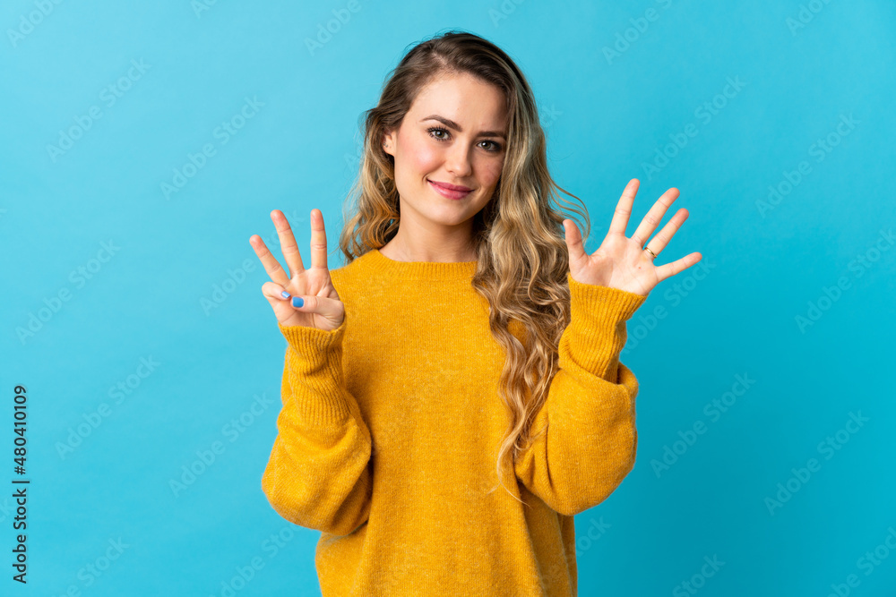 Young Brazilian woman isolated on blue background counting eight with fingers Young Brazilian woman isolated on blue background counting eight with fingers
