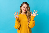 Young Brazilian woman isolated on blue background counting eight with fingers