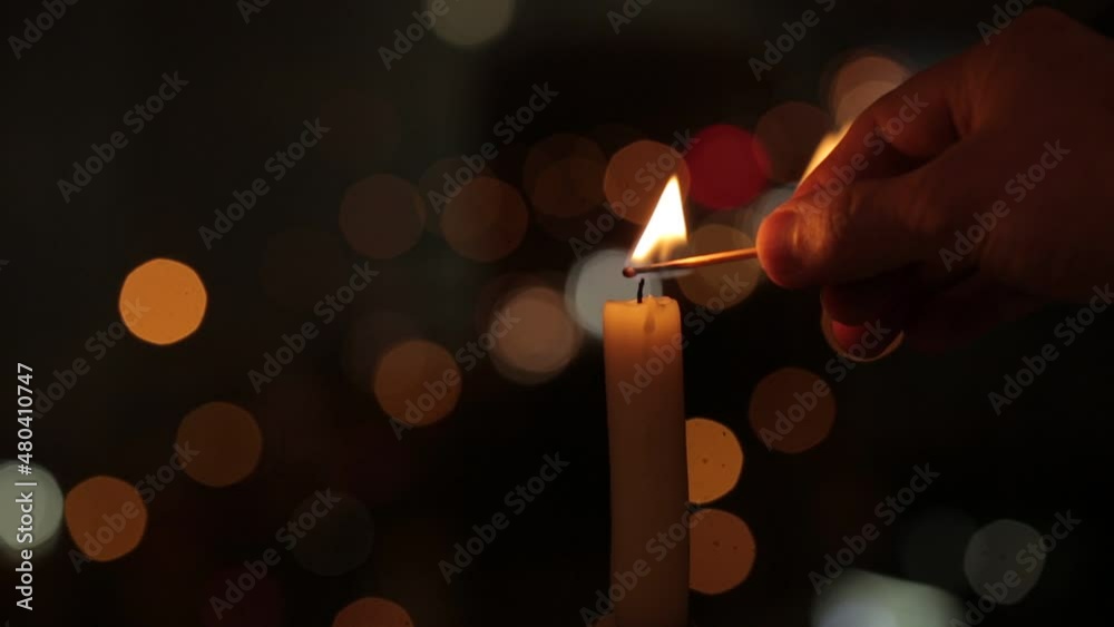 The candle light up over the bokeh window glass in the dark.