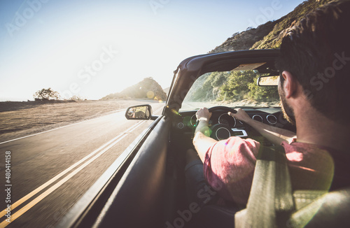 Man driving convertible car in Los angeles, santa monica photo