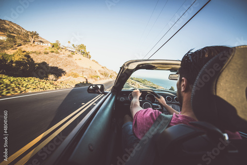 Man driving convertible car in Los angeles, santa monica