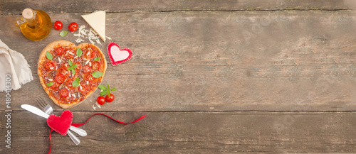 Valentine's Day banner with pizza heart on an old wooden background with copy space
