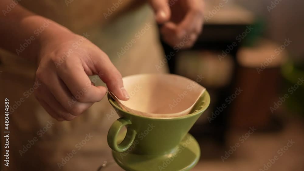 slow-motion shot of barista who making a hot of coffee by filter drip pouring water process, homemade coffee in morning at home or cafe, vintage hand brewing water over roasted coffee beans slow-motion shot of barista who making a hot of coffee by filter drip pouring water process, homemade coffee in morning at home or cafe, vintage hand brewing water over roasted coffee beans