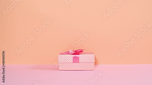 Wallpaper Mural Pink gift box with ribbon appear and open and heart balloon  fly from gift. Stop motion Torontodigital.ca