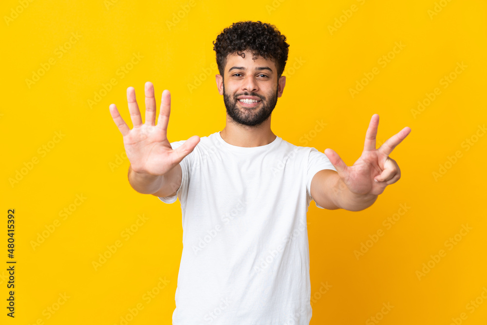 Young Moroccan man isolated on yellow background counting eight with fingers Young Moroccan man isolated on yellow background counting eight with fingers