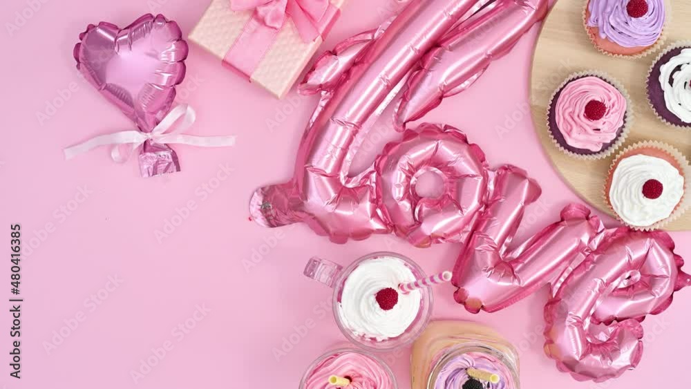 Valentine's day decoration balloons and cup cakes move on right side of pastel pink theme. Stop motion Valentine's day decoration balloons and cup cakes move on right side of pastel pink theme. Stop motion