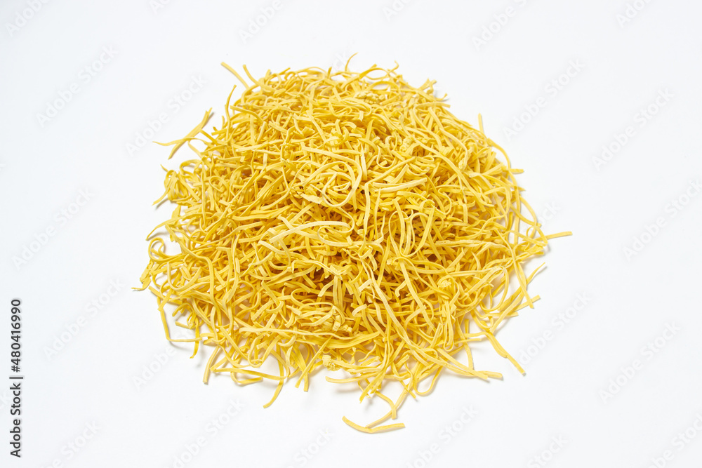 Egg noodles on a white background. Isolated dry homemade noodles. Traditional pasta