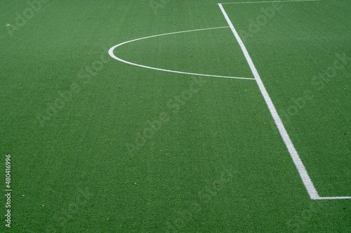 Partial image of green artificial turf in sports stadium