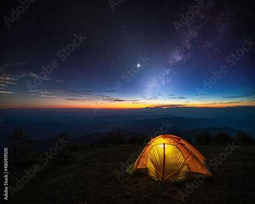 Tent camping with twilight sky and Milky Way background