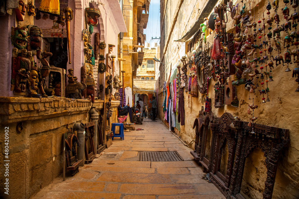 A narrow street with local artifacts for sale within Jaisalmer fort, Rajasthan, India.