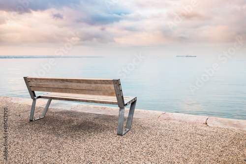 Canvas Print A viewing platform with a lonely romantic bench on the embankment by the calm se