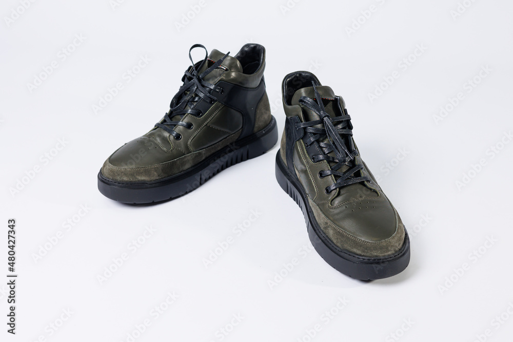 Leather short men's boots on a white background. Winter boots collection 2022. Leather short men's boots on a white background. Winter boots collection 2022.