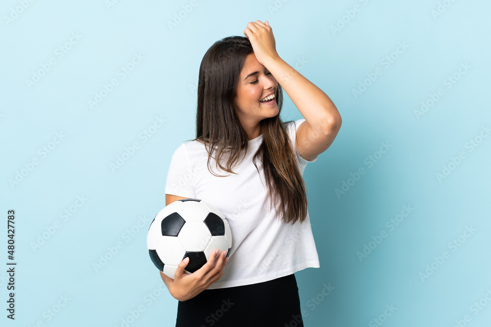 Young football player brazilian girl isolated on blue background has realized something and intending the solution Young football player brazilian girl isolated on blue background has realized something and intending the solution