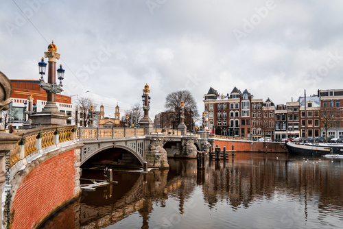 View at the Blauwbrug, or Blue bridge in English in the historic city center of Amsterdam photo