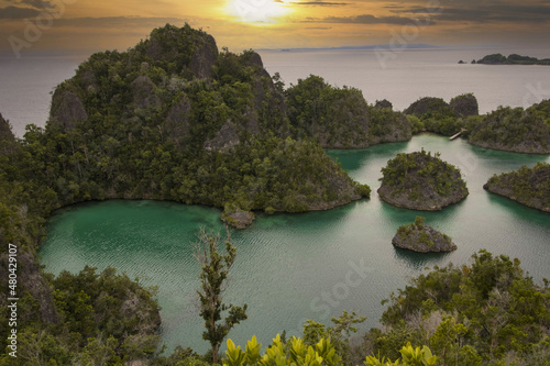 view of small islands rising up out of water in raja ampat
