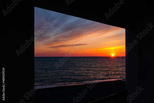 rectangular frame through which the sea shore is visible