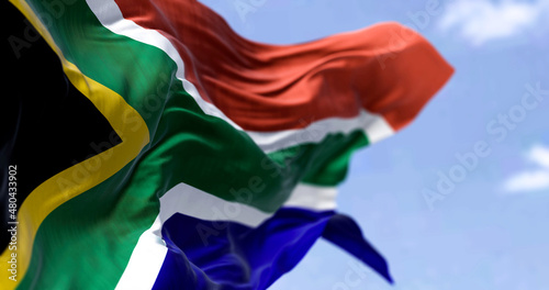 Detailed close up of the national flag of South Africa waving in the wind on a clear day photo