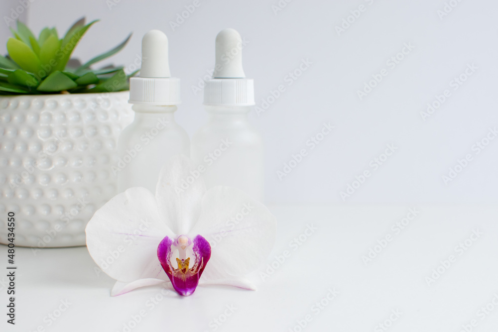 Two bottles of skincare serums in a white clean background Two bottles of skincare serums in a white clean background