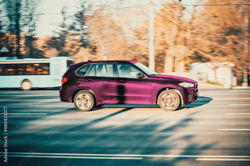 Car BMW X5 Third Generation F15 Driving in City with Motion Blur