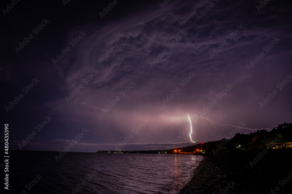 Lightning over the sea at night in the south