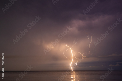 Obraz na płótnie Lightning over the sea at night in the south w salonie